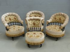 A SET OF THREE EBONISED LATE VICTORIAN SALON ARMCHAIRS UPHOLSTERED IN BEIGE GROUND FLORAL TEXTILE,