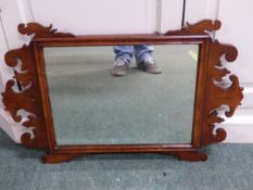 A WALNUT FRAME FRET DECORATED WALL MIRROR. 74 x 78cms.