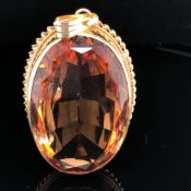 A LARGE PASTE SINGLE STONE PENDANT. SET WITH AN OVAL SHAPED MIXED CUT ORANGE PASTE, MEASURING APPROX