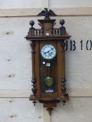 A MAHOGANY CASED GUSTAVE BECKER VIENNA TYPE WALL CLOCK STRIKING ON A COILED ROD, THE DIAL WITH