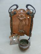 AN ART NOUVEAU COPPER FIRE SCREEN, THE IRON FRAME LOOPED ABOVE THE TOP CORNERS, THE COPPER WITH