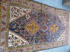 AN ANTIQUE PERSIAN QASHQAI RUG. DIMENSIONS 250 x 138cms.