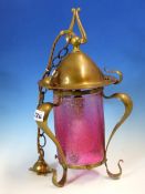 A DRESSER STYLE BRASS AND CRINKLED CRANBERRY GLASS CEILING LANTERN, THE CYLINDRICAL GLASS BELOW A