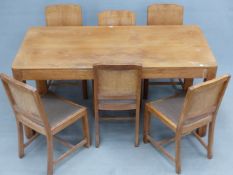 A HEALS OAK DINING TABLE AND SIX CHAIRS, THE LATTER WITH CANTED SQUARE BACKS, DROP IN SEATS AND