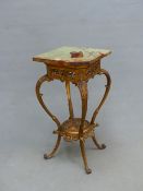 A GREEN STONE TOPPED GILT METAL STAND, THE SQUARE TOP ABOVE A PIERCED FOLIATE APRON, THE CABRIOLE