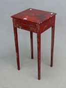 A RED GROUND VINTAGE CHINOISERIE TABLE WITH TWO DRAWERS ABOVE THE TAPERING SQUARE LEGS. W 35.5 x D