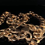 A 9ct GOLD CURB NECKLACE, LENGTH 56.5cms, WEIGHT 34.5grms.