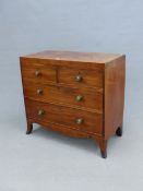 A GEORGE III MAHOGANY CHEST OF TWO SHORT AND TWO LONG DRAWERS ABOVE AN APRON CURVING INTO THE