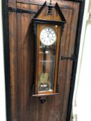 AN EBONY TRIMMED ROSEWOOD CASED VIENNA REGULATOR STRIKING ON A COILED ROD, THE WHITE ENAMEL