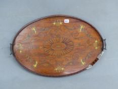 AN OVAL MARQUETRIED SATIN WOOD TRAY WITH BRASS HANDLES AT EACH END OF THE GALLERY, PUTTI HOLDING