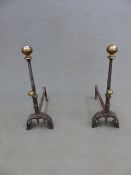 A PAIR OF VICTORIAN IRON FIRE DOGS WITH BRASS BALL TOPS ON SPIRAL TWIST COLUMNS AND FLUTED ROUND