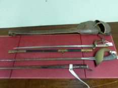 TWO LEATHER CASED SWORDS, THE GIEVE & SONS NAVAL SWORD IN BRASS MOUNTED BLACK LEATHER SCABBARD,