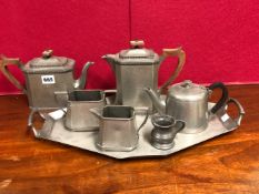 A CRAFTSMAN PEWTER FOUR PIECE TEA SET ON A TRAY EACH WITH HAMMERED DECORATION, TOGETHER WITH A SMALL