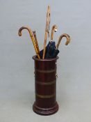 A BRASS BOUND MAHOGANY STICK STAND WITH LION MASK AND RING HANDLES. H 63cms. TOGETHER WITH TWO OF