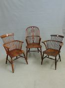 AN ANTIQUE ELM AND ASH WINDSOR CHAIR TOGETHER WITH TWO COMB BACK ELBOW CHAIRS