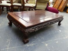 A CHINESE HARDWOOD COFFEE TABLE, THE RECTANGULAR TOP OVER AN APRON PIERCED AND CARVED WITH DRAGONS