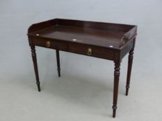 A GEORGE III MAHOGANY WASHSTAND, THE THREE QUARTER GALLERIED TOP ABOVE TWO DRAWERS WITH STOP