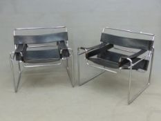 A PAIR OF LE CORBUSIER LC2 TUBULAR CHROME AND BLACK LEATHER ARM CHAIRS