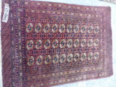 AN ANTIQUE TEKKE BOKHARA RUG, 152 X 106cm, TOGETHER WITH AN ANTIQUE PERSIAN SHIRAZ RUG