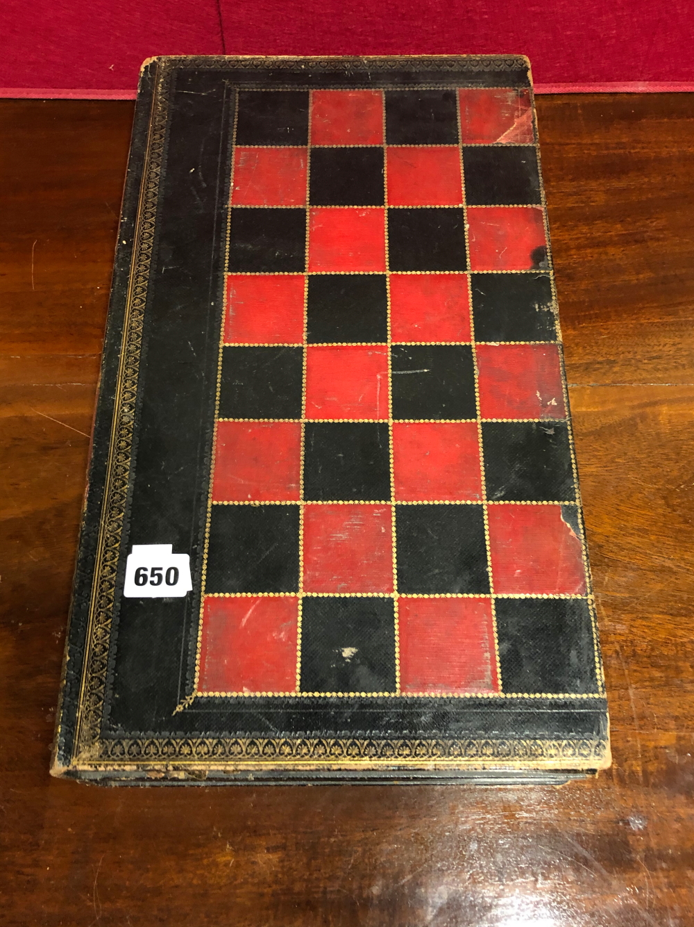 A RED, BLACK AND GILT LEATHER MOUNTED CHESS BOARD DISGUISED AS TWO VOLUMES ON THE HISTORY OF ENGLAND
