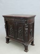 AN OAK SIDE CABINET CARVED IN RENAISSANCE STYLE WITH FOLIAGE ON THE LONG DRAWER AND RAMS HEAD