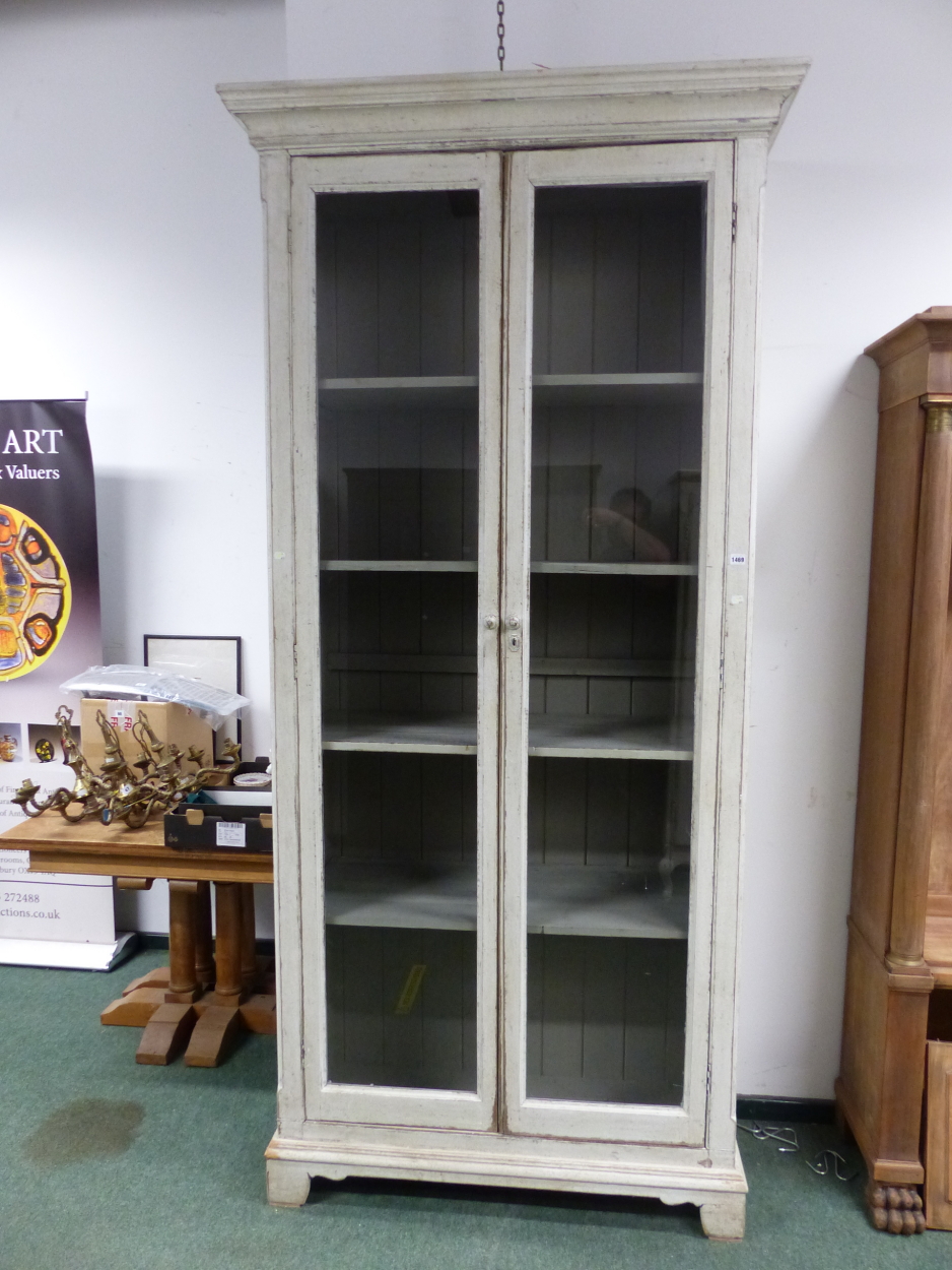 A 19th C. FRENCH GREY PAINTED DISPLAY CABINET, THE GLAZED DOORS ABOVE BLOCK FEET. W 117 x D 50 x H
