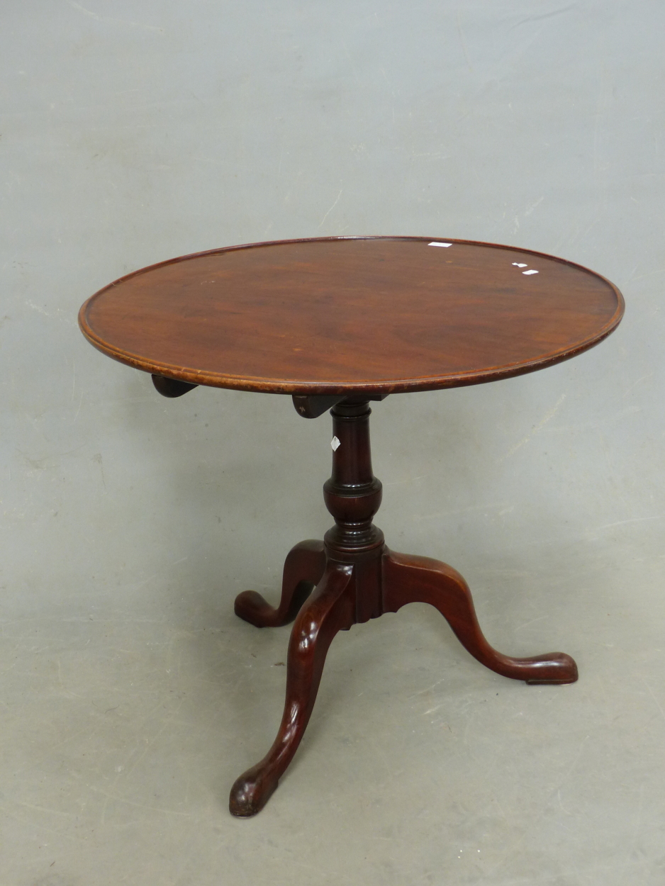 AN ANTIQUE MAHOGANY BIRD CAGE TRIPOD TABLE, THE DISHED CIRCULAR TOP ON BALUSTER COLUMN, THE THREE