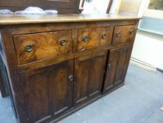 A 19th CENTURY ELM COUNTRY MADE DRESSER BASE, THREE APRON DRAWERS ABOVE TWO PANELLED CUPBOARD DOORS,