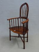 AN INTERESTING RUSTIC COMB BACK ARMCHAIR, SHAPED SEAT, TURNED LEGS JOINED BY CROSS STRETCHER.