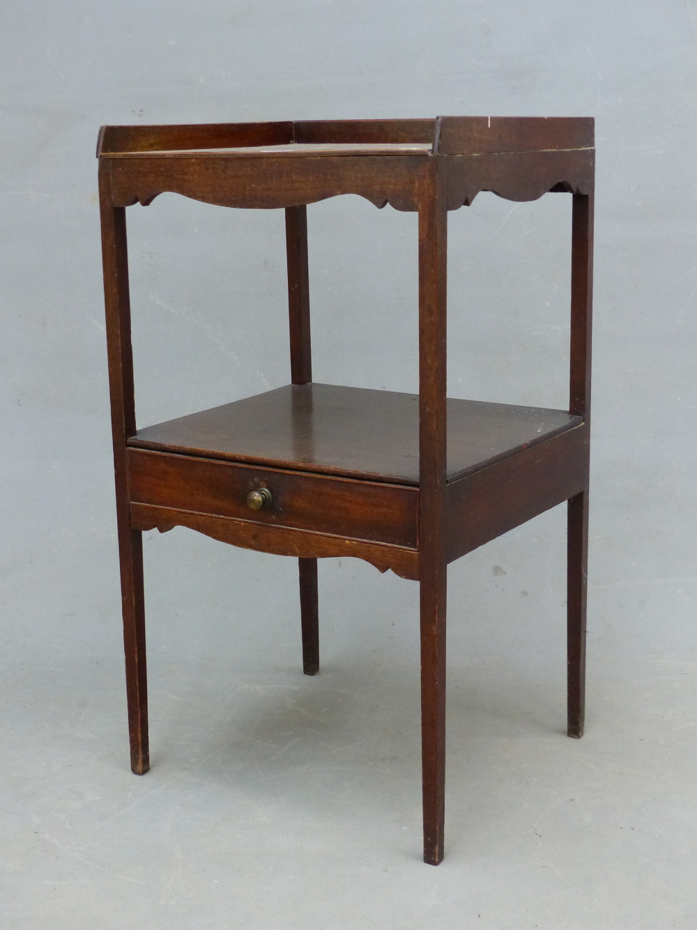 A GEORGE III AND LATER MAHOGANY WASHSTAND WITH THREE QUARTER GALLERIED TOP AND A DRAWER BELOW THE