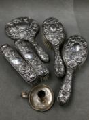 A VICTORIAN STYLE FIVE PIECE DRESSING TABLE BRUSH AND MIRROR SET, WITH DEEP RELIEF REPOUSSE