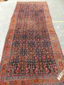 AN ANTIQUE PERSIAN BIDJAR RUG, 326 X 138cm.