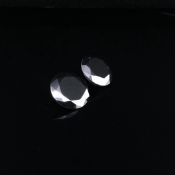 TWO SIMILAR BLACK ROUND BRILLIANT CUT DIAMONDS THE FIRST MEASURING 11.1 DIA X 6.9mm DEPTH . THE