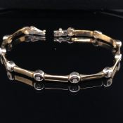 A 9ct YELLOW GOLD AND DIAMOND BAR AND RUB OVER SET BRACELET LENGTH 19.5.cms WEIGHT 11.9gm.