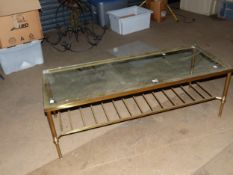 A GLAZED BRASS COFFEE TABLE, THE REEDED TAPERING CYLINDRICAL LEGS JOINED BY A LADDER TIER. W 121 x D