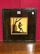 A ROWLEY GALLERY LABELLED MARQUETRY PANEL DEPICTING A YOUTH PLAYING A PIPE BELOW A TREE IN EBONY