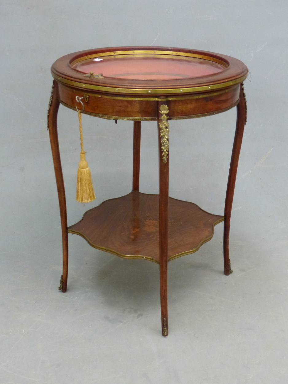 A FRENCH LOUIS XV STYLE INLAID ROUND BIJOUTERIE TABLE WITH BEVELLED GLAZE TOP, BRASS MOUNTS SHAPED