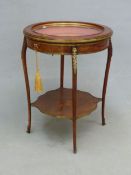 A FRENCH LOUIS XV STYLE INLAID ROUND BIJOUTERIE TABLE WITH BEVELLED GLAZE TOP, BRASS MOUNTS SHAPED