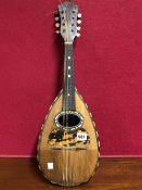 AN EIGHT STRING MANDOLIN PREDOMINENTLY IN ROSEWOOD BUT WITH TORTOISESHELL INLAY ON THE SOUND BOARD