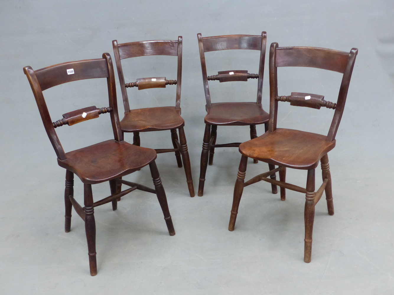 A SET OF FOUR ANTIQUE OXFORD CHAIRS WITH SADDLE SEATS AND RING TURNED BALUSTER LEGS