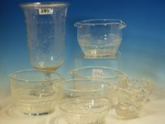 FOUR DOUBLE LIPPED CLEAR GLASS RINSING BOWLS. Dia. 11cms. A MINIATURE GLASS JUG. H 6cms. AN OVAL