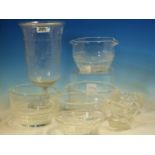 FOUR DOUBLE LIPPED CLEAR GLASS RINSING BOWLS. Dia. 11cms. A MINIATURE GLASS JUG. H 6cms. AN OVAL