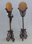 A PAIR OF CHINESE PIERCED AND CARVED HARDWOOD BRONZE MIRROR STANDS, EACH TOP SUPPORTED ON A COLUMN