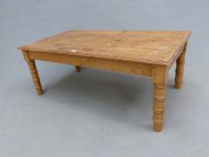 A PINE COFFEE TABLE, THE FOUR PLANK RECTANGULAR TOP ON CYLINDRICAL LEGS TURNED TO SIMULATE BAMBOO. W