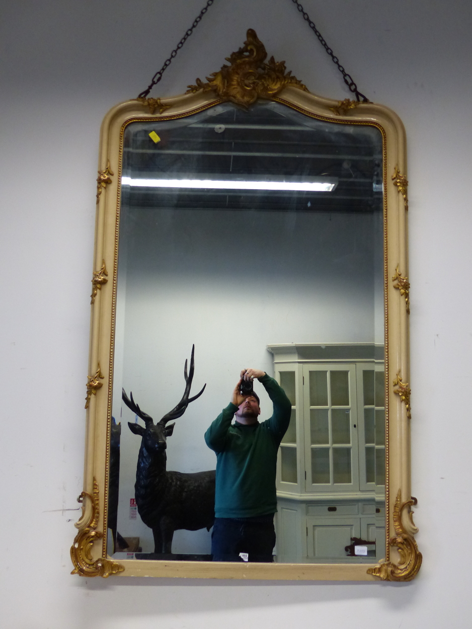 AN ANTIQUE FRENCH PAINTED AND GILT OVERMANTLE /PIER MIRROR. SHAPED BEVELLED PLATE. 180 x 110cms.