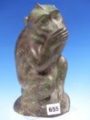 AN EARLY 20th C. BRONZE FIGURE OF A MONKEY SEATED WITH ONE HAND TO ITS MOUTH. H 25cms.