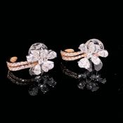 A PAIR OF 18ct WHITE AND ROSE GOLD DIAMOND SCREW BACK EARRINGS. PEAR CUT DIAMOND PETALS SET IN