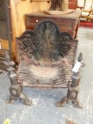 AN IRON FIRE BACK CAST WITH A THISTLE IN THE ARCHED TOP ABOVE A LION. 77 x 69cms. TOGETHER WITH A