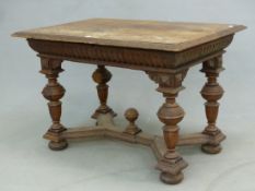 AN ANTIQUE CONTINENTAL CARVED OAK CENTRE TABLE, QUARTER VENEERED TOP, APRON DRAWER, BALUSTER