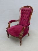 A VICTORIAN MAHOGANY SHOW FRAME ARMCHAIR, THE BACK BUTTON UPHOLSTERED IN WINE RED VELVET